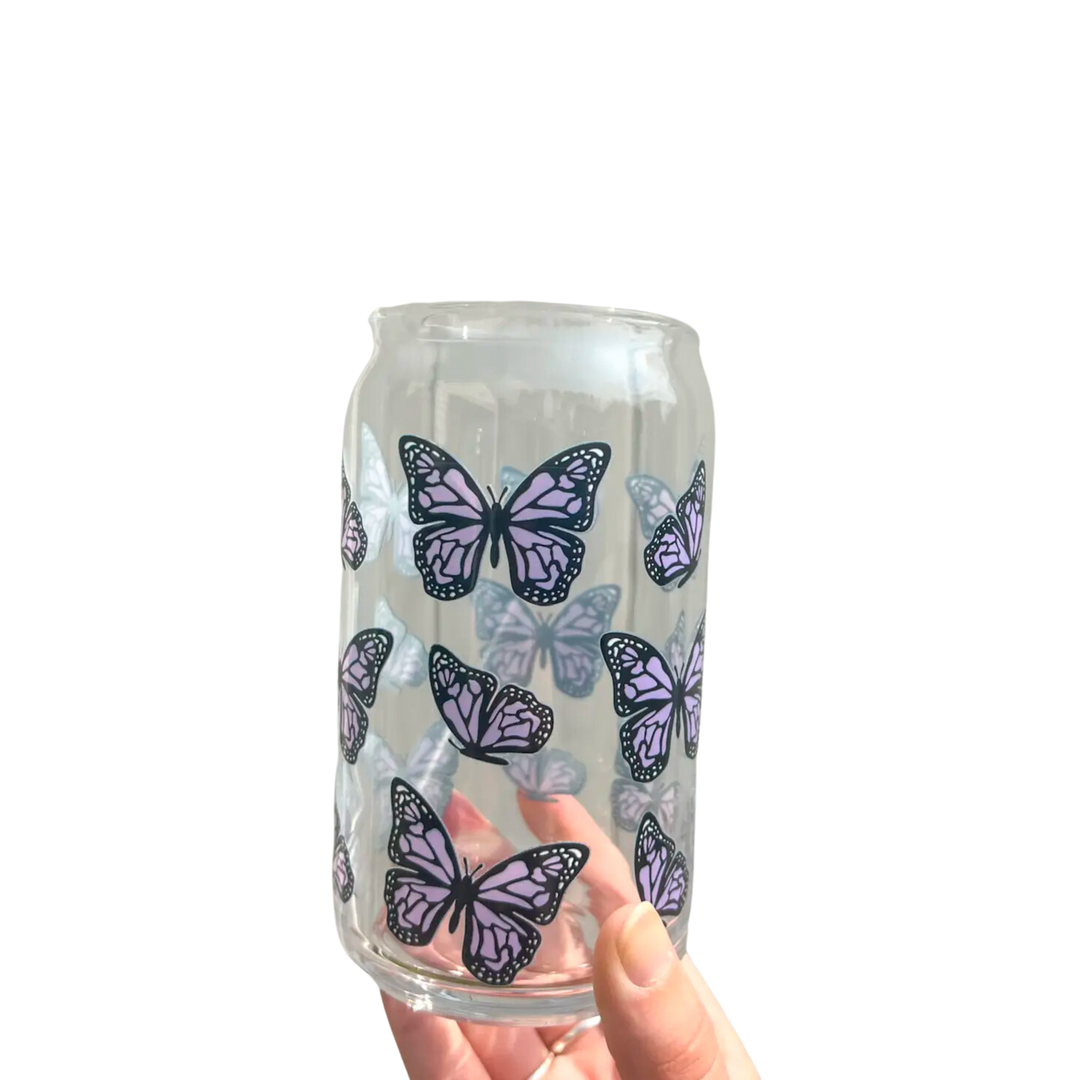 Glass cup with purple butterflies.  This 16 oz can glass cup is a great choice for hot and cold beverages. Its butterfly design is printed seamlessly around the glass with high-quality, durable ink for long-lasting durability. Plus, it is dishwasher safe and can last through more than 300 dishwasher cycles on the top rack.