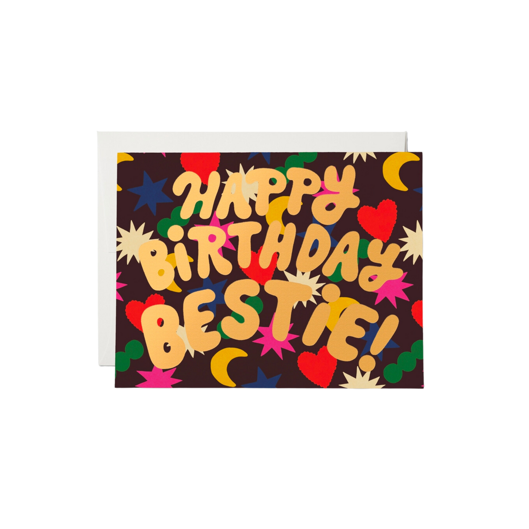 Colorful shapes on black background with gold text "Happy Birthday Bestie!". This heavy-weight, 100lb card stock is printed and foil stamped. Its dimensions measure at 4.25 by 5.5 inches. Artwork is illustrated by Krista Perry and the card is printed on recycled paper in the USA. It is blank inside.