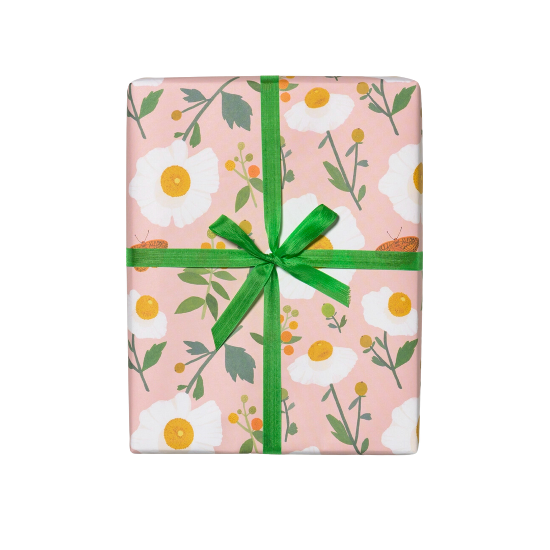 White flowers with green stems on a pink background. Sheet - Single (1) 19 x 27 inch sheet   Roll - Three (3) 19 x 27 inch sheets of flat wrap, rolled and sealed together.   Illustrated by Kate Pugsley. Printed in USA, on recycled paper.